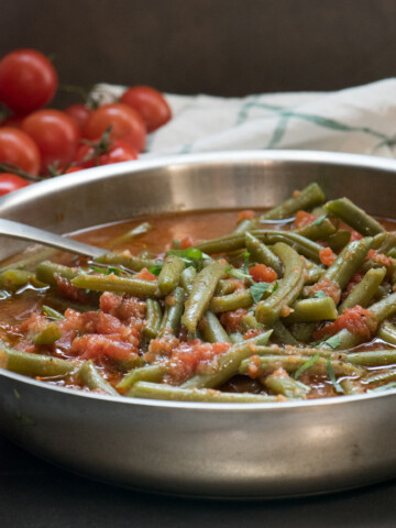 Mediterranean Green Beans make an easy and healthy side dish or appetizer. Great piping hot or at room temperature. Enjoy! | The Recipe Wench