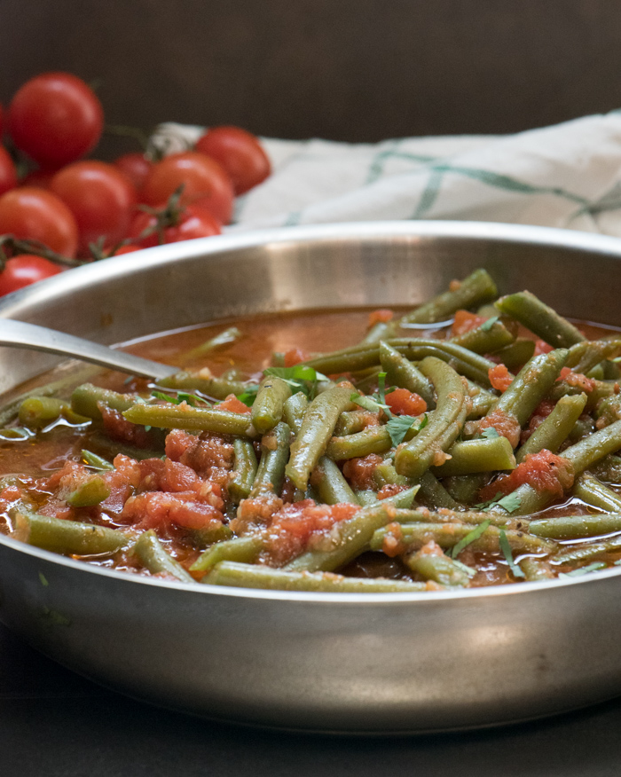 Mediterranean Green Beans make an easy and healthy side dish or appetizer. Great piping hot or at room temperature. Enjoy! | The Recipe Wench