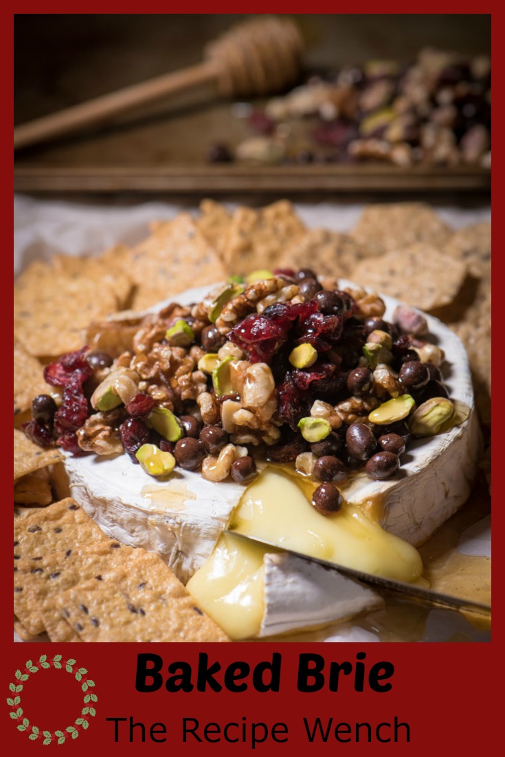 Baked Brie is one of the easiest last-minute appetizers I can think of! Top with nuts and dried fruit, drizzle honey and Enjoy! | The Recipe Wench