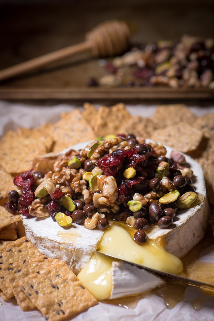 Baked Brie is one of the easiest last-minute appetizers I can think of! Top with nuts and dried fruit, drizzle honey and Enjoy! | The Recipe Wench