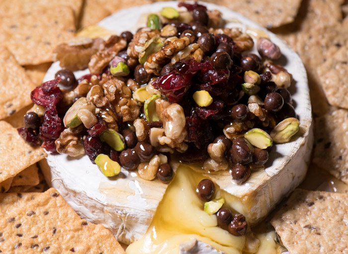 Baked Brie is one of the easiest last-minute appetizers I can think of! Top with nuts and dried fruit, drizzle honey and Enjoy! | The Recipe Wench