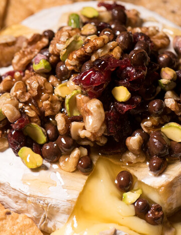 Baked Brie is one of the easiest last-minute appetizers I can think of! Top with nuts and dried fruit, drizzle honey and Enjoy! | The Recipe Wench