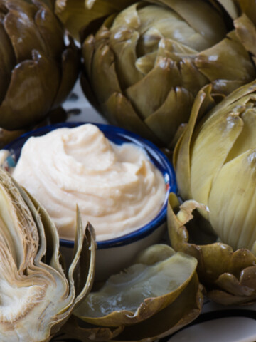 This simple dipping sauce for artichokes will drive you wild! A little butter. A little mayo. Some seasonings. Perfection! | The Recipe Wench