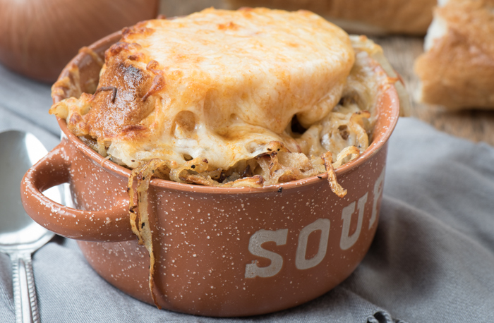 A quick and simple French Onion soup recipe. Top with hearty French bread and melty cheese for a delicious meal! | The Recipe Wench