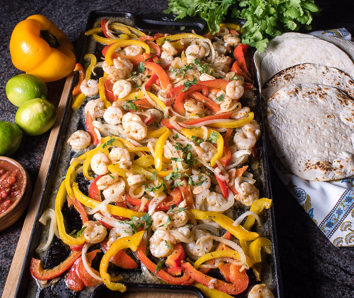 Shrimp fajitas are a brilliant and easy meal that can be cooked in the oven and served family style! | The Recipe Wench